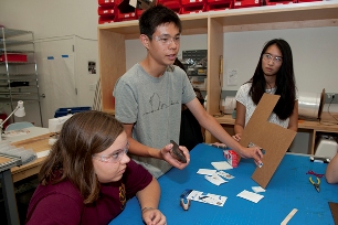 Flanked by 18-year-old Zoe Nuyens (left) and 17-year-old Justine Sun, Alex Lee, also 17, demonstrates a system for detecting surgical gauze that was designed by local high school students. The trio were among the 26 students who attended at a bioengineering "boot camp" held at Stanford University.