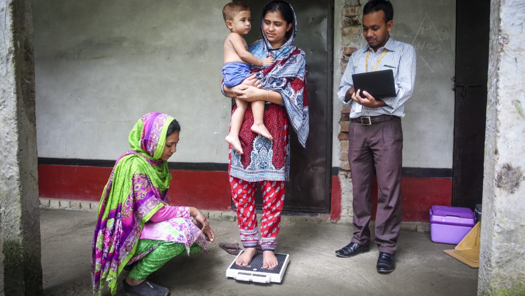a researcher with two women and a child in Bangladesh