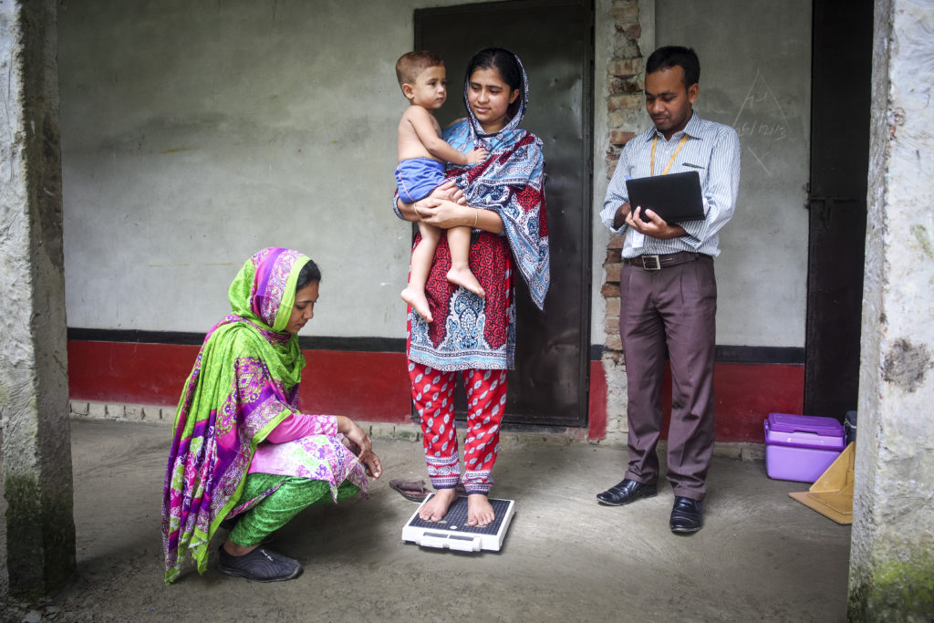 a researcher with two women and a child in Bangladesh