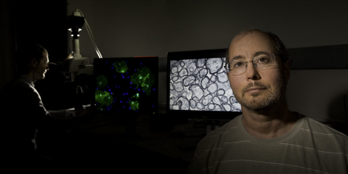 Ben Barres pictured in front of a computer screen