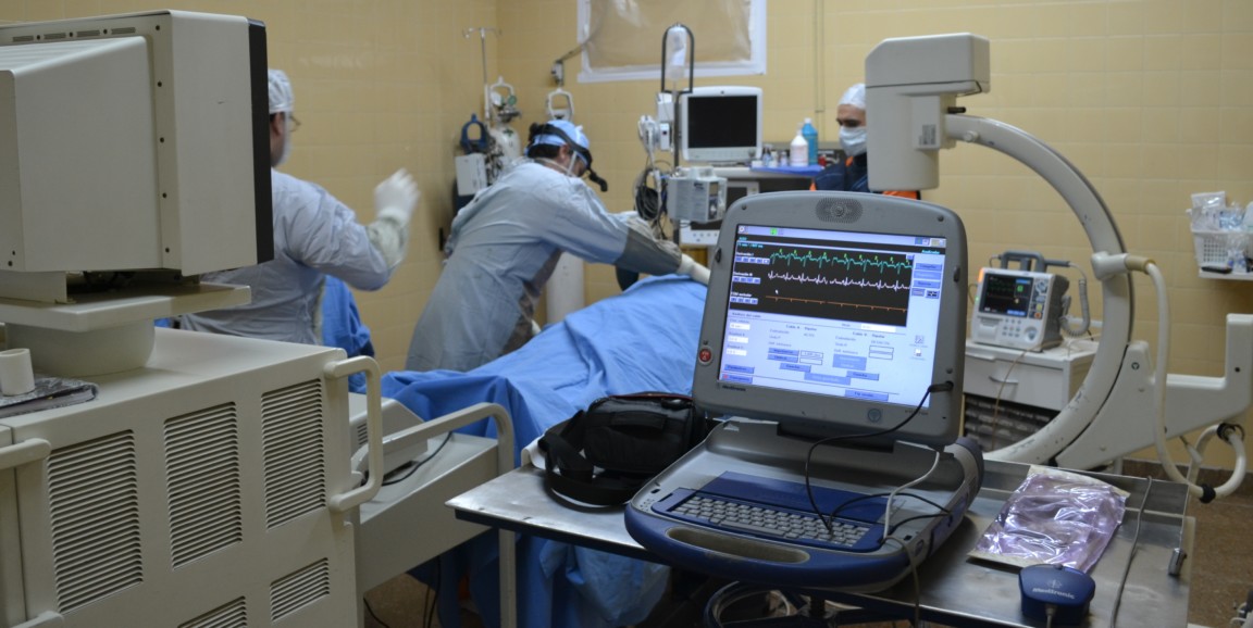 doctors working on a patient surrounded by technology