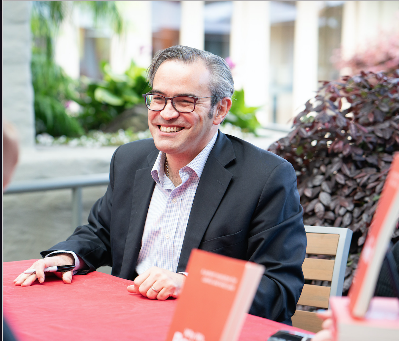 Victor Montori, MD, signing copies of his book, Why We Revolt