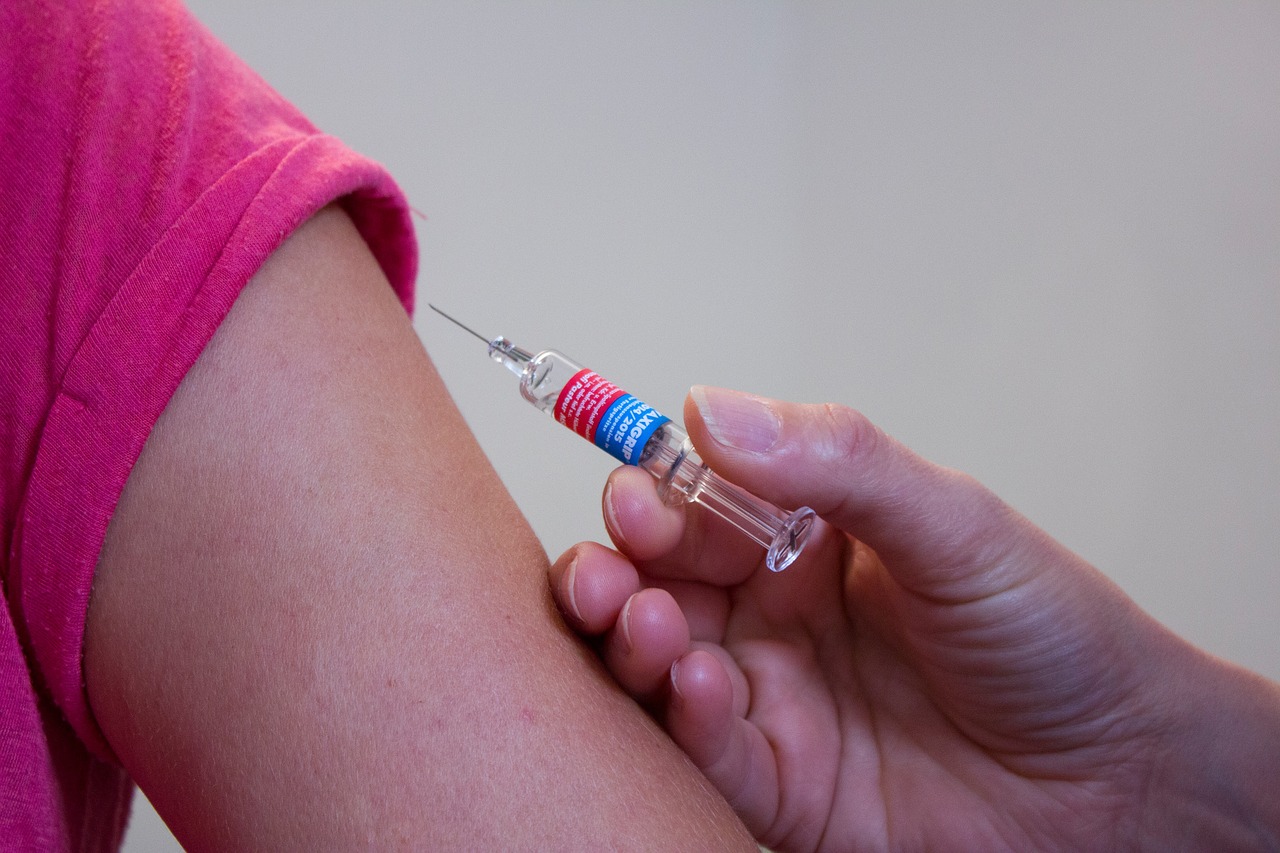 arm and vaccination syringe