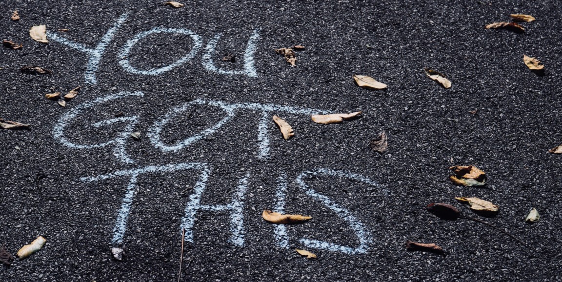 Chalk words on pavement: you got this