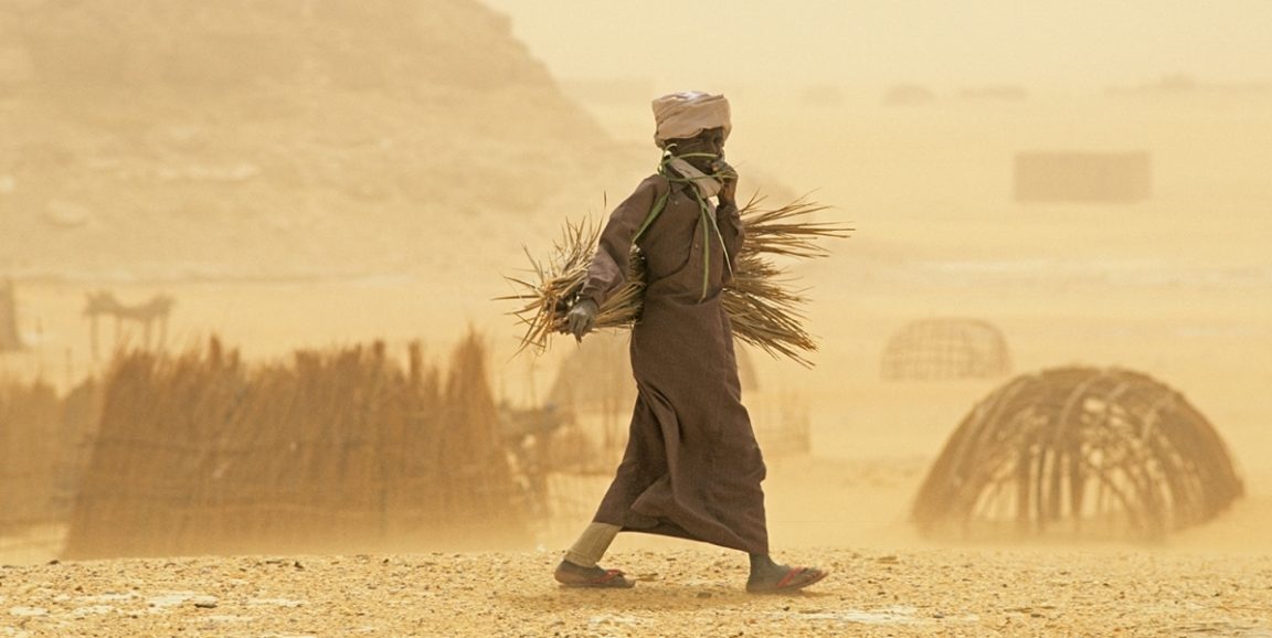 A man walks through a sandstorm in Chad