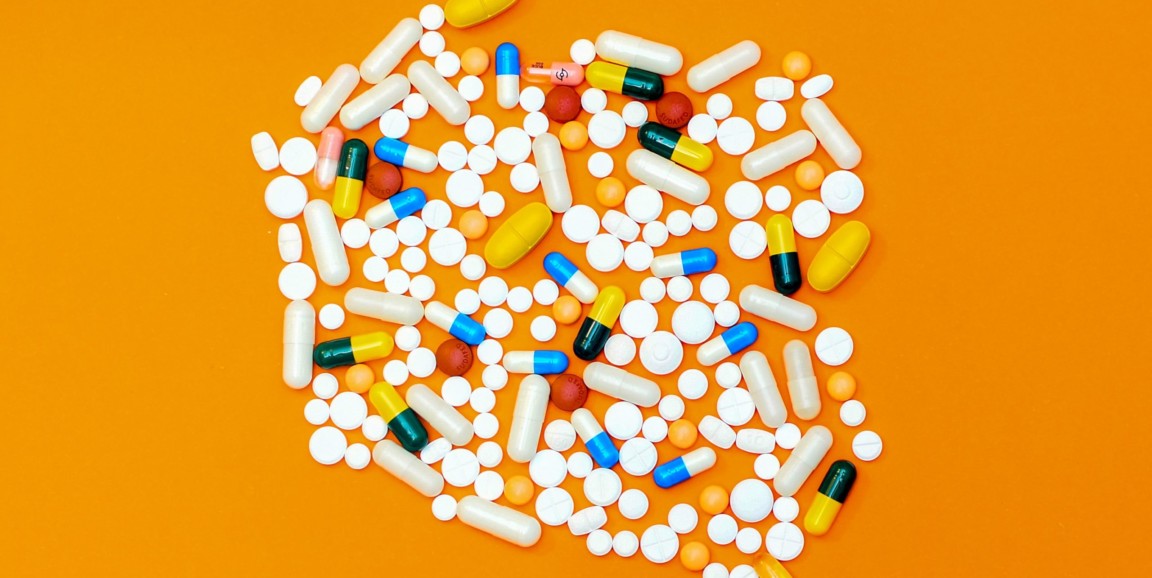 Pills on an orange backdrop