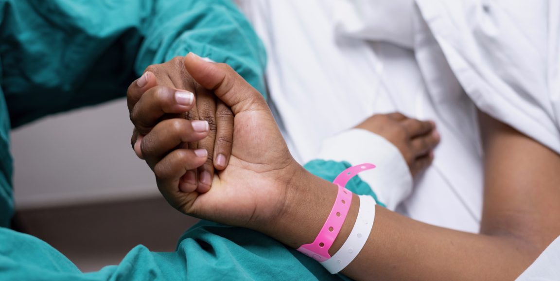 doctor holding a patient's hand