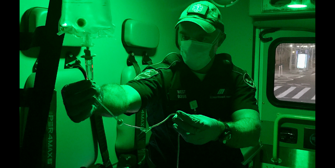 Zach West adjusting IV in ambulance