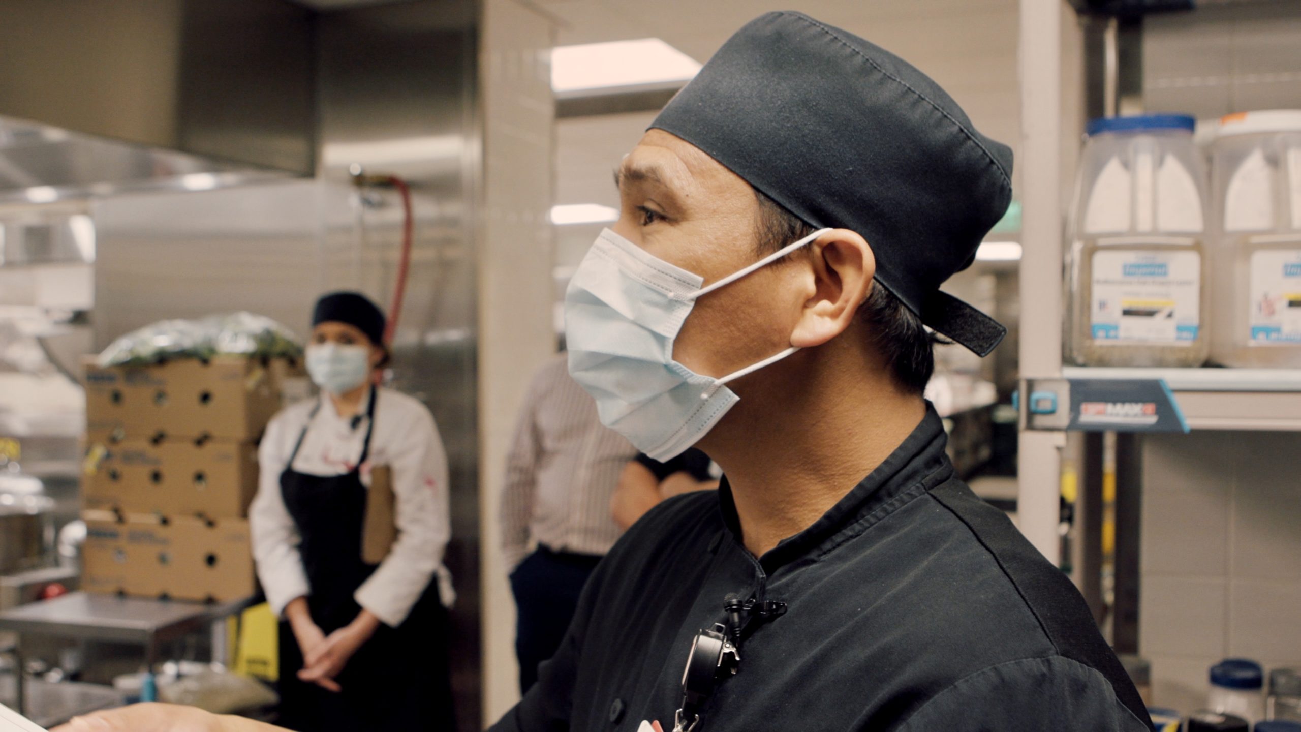 Each morning, Noriel San Pedro, chef and supervisor of Food Services at Stanford Health Care, does his rounds -- checking the equipment, food supply, and leading staff huddles in the kitchen. Photo by Kevin German.