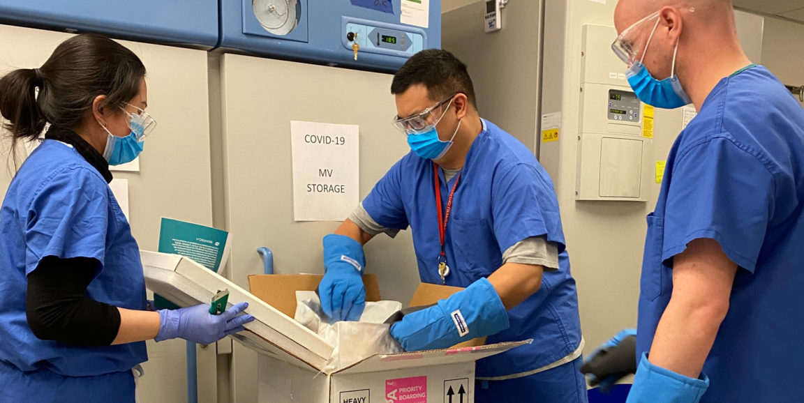 The Pfizer COVID-19 vaccine being received at Stanford by pharmacy team members Maria Deguzman, Daniel Fong and Adam Silva.