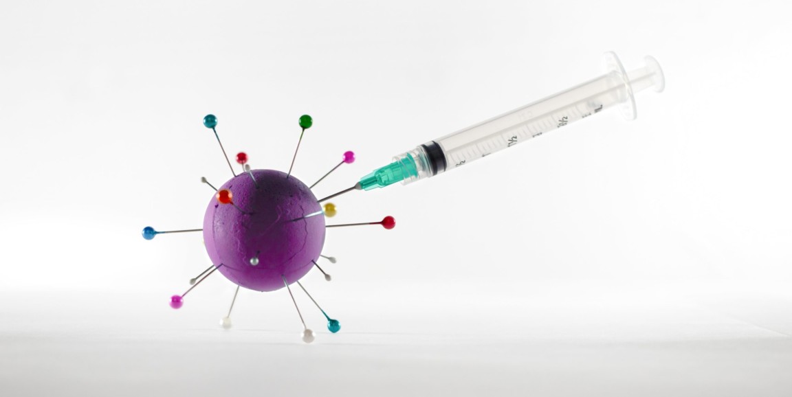 A syringe injects a virus.